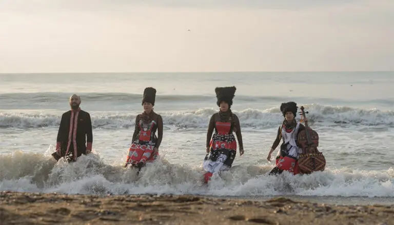 dakhabrakha on the beach in shallow waves 768x439