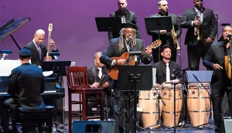 juan de marcos playing guitar on stage with the afro cuban all stars 768x439
