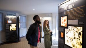 a man and woman looking at an exhibit at Josiah Henson Museum and Park.