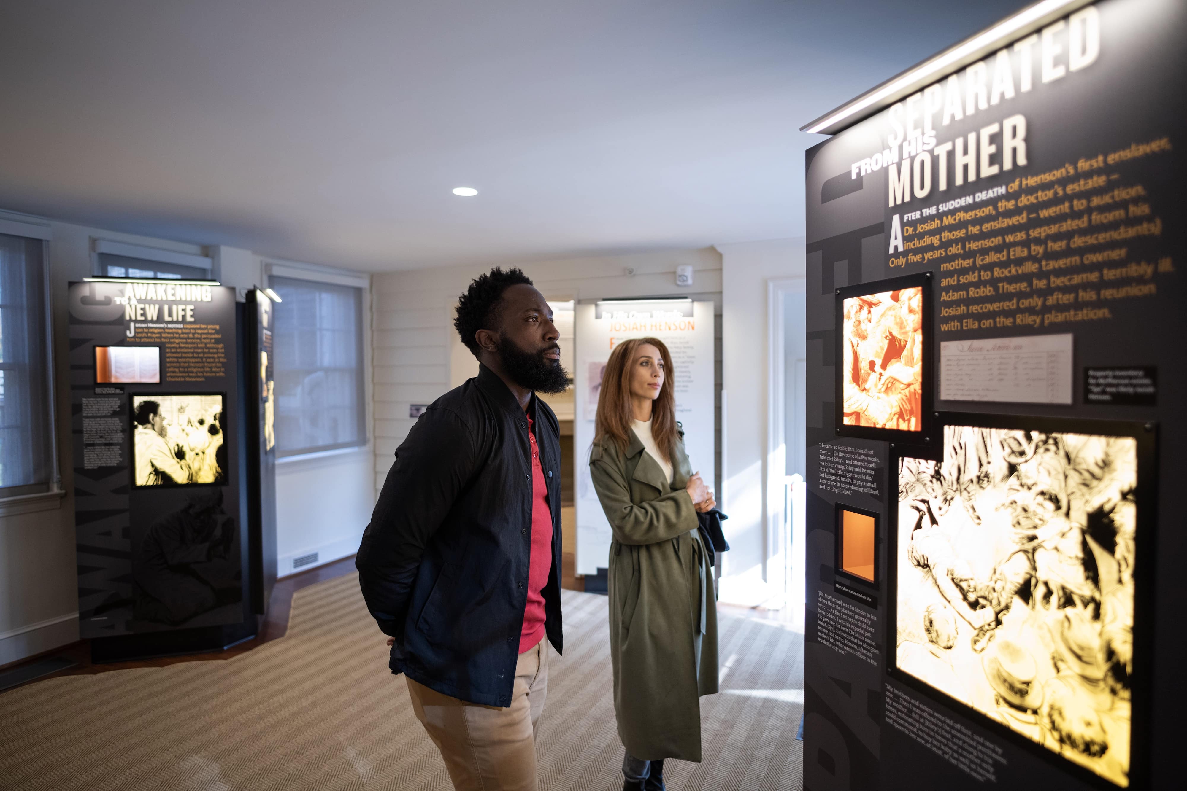 a man and woman looking at an exhibit at Josiah Henson Museum and Park.