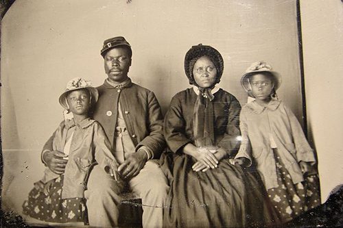 Unidentified African American soldier with wife and two daughters