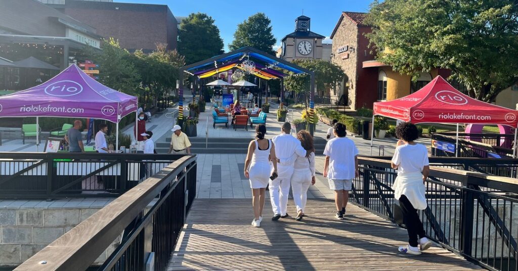 a family walking on a boardwalk to the taste of rio event