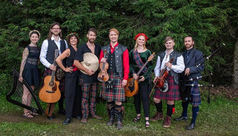 sean heely celtic christmas ban outside in front of trees with their instruments 768x439
